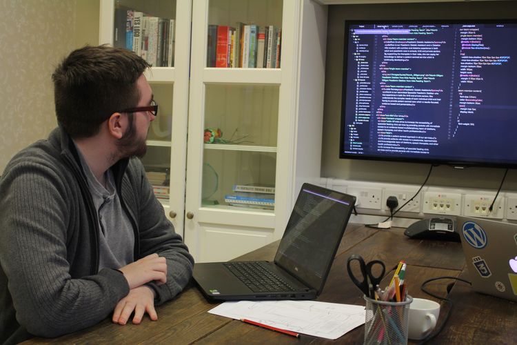 Barry Tickle reviewing website code on a screen