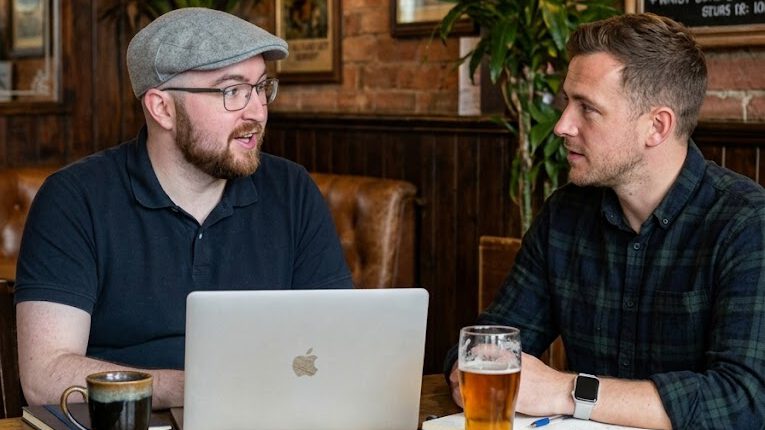 Barry Tickle discussing a web project with a colleague
